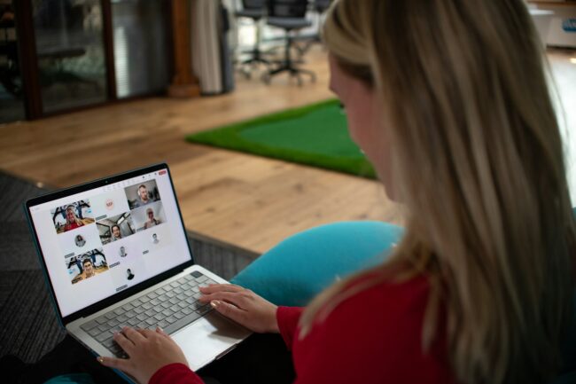 image of a woman on a laptop in a customer research group