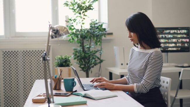 woman reading documents on laptop to illustrate how to do qualitative research without coding