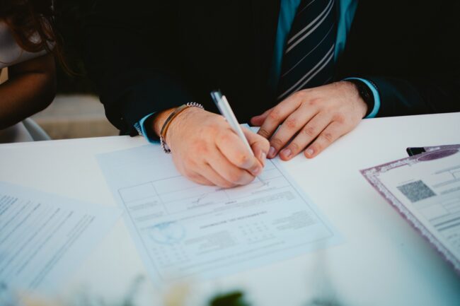 Person reviewing and annotating documents at a desk